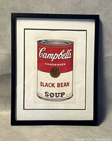 Full view of framed Campbell's Black Bean Soup lithograph print against a grey background.
