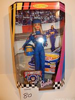 Front view of Barbie 50th Anniversary NASCAR doll in original sealed collector edition box with NASCAR 50th Anniversary logo.