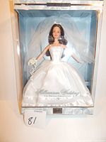 Barbie Millennium Wedding doll displayed inside original packaging. Doll wears a white strapless wedding dress with veil, holding a bouquet. Packaging mentions The Bridal Collection and Millennium Wedding.