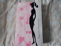 Box front with pink and black silhouette artwork of a woman in profile and Barbie branding.