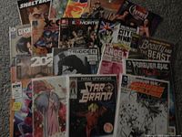 Box of mixed comics from Marvel, DC, Image, Dark Horse including Star Brand, Ex Mortis, Angel, Forever Evil and others laid out on a carpet