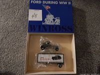 Die cast model Ford truck inside original blue box with American WWII memorial graphic and 'Winross' branding on the lid, packaging includes a sticker with 4/8