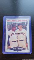 Front side of 1960 Topps baseball card showing Willie Mays and Alvin Rigney labeled Master & Mentor Giants