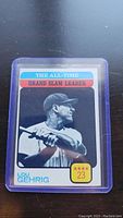 Vintage 1973 Topps Lou Gehrig baseball card in protective sleeve, showing the black and white photo of Lou Gehrig with batting stance and colorful banner at top.