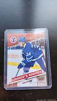 Close-up image of a single Auston Matthews rookie hockey card in a clear plastic protective holder.