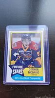 Photo of a 2014 Hot Shot Prospects Connor McDavid Future Stars hockey card in protective sleeve showing the front design and player image.