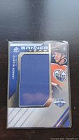 Front of the Connor McDavid Banner Year jersey card showing large blue fabric swatch and player image.