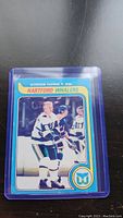 Front of Gordie Howe hockey card in Hartford Whalers uniform in plastic sleeve.