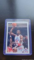 Photo of a Michael Jordan 1990-91 Upper Deck NBA All-Star basketball card encased in protective plastic.