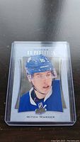 Front view of Mitch Marner rookie hockey card in protective hard plastic sleeve, featuring player in Toronto Maple Leafs jersey and helmet.