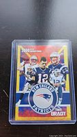 Front view of 2000 Tom Brady New England Patriots Gold Rookie Card in plastic sleeve