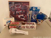 Lot showing multiple Blue Jays collectibles including signed baseball, card box, fan kit, and display kit.