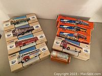 Two stacks of boxed Corgi model buses showing a total of nine boxes.