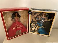 Photo showing two collectible Barbie dolls in original packaging: 2014 Holiday Barbie Noel and Ken 50th Anniversary edition.
