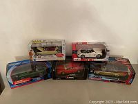 Front view of all five model cars in original boxes
