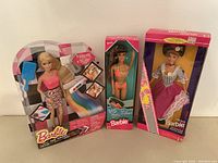Full lot of three new in box Barbie dolls.