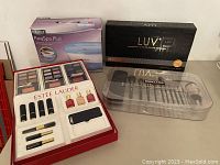 Overview of all items: Homedics ParaSpa Plus paraffin spa, LUV hair styler, Estée Lauder cosmetics set, Kirkland brush set.
