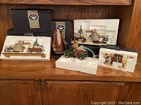 Overview of Williraye Studio Christmas figures with Styrofoam packaging and boxes