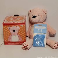 Photo of the bear with the original box and scent pack in front of the bear.