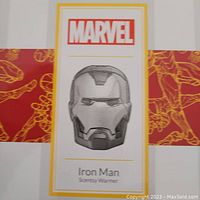 Box showing Marvel branding and image of Iron Man helmet warmer.