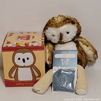 Plush owl Oakley with box and Luna scent sachet placed in front.