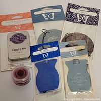 Photo showing all items including travel tin, air fresheners, and scent samples.