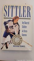 Front cover of the hardcover book titled "Sittler" with image of Darryl Sittler in hockey uniform.