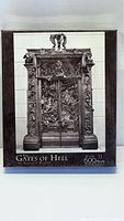 Front view of the sealed puzzle box showing the image of The Gates of Hell sculpture by Auguste Rodin in black and white.