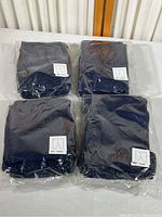 Four packages of navy blue children's pants, each package containing 5 pants, total 20 pants, sealed except one opened package for inspection.