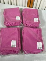 Four sealed packages of fuchsia pink child’s pants, each labeled size 4 years, color fuchsia, folded inside clear plastic packing.