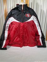 Front view of the jacket showing black, red, and white color sections with 49ers logo on left chest.