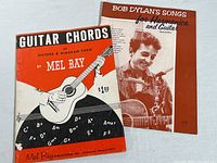 Photo showing both the Mel Bay Guitar Chords and Bob Dylan Songs for Harmonica and Guitar books together on a white background.