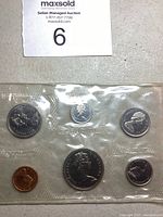 Photo of half of the coin set in sealed clear plastic packaging including six coins of various denominations with Queen Elizabeth II portraits visible.