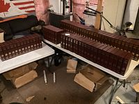 Wide view of the entire collection arranged on tables showing rows of dark brown leather holders containing National Geographic magazines.