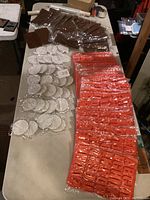Table with multiple packs of silicone molds in orange, brown, and white packaging.