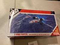 Box top showing Star Wars X-Wing Fighter model kit artwork and branding.