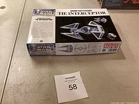 Photo showing box of Star Wars Sienar Fleet Systems TIE Interceptor model kit by Fine Molds with auction lot number 58