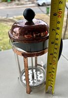 Side view of French press coffee maker with tape measure showing approx. 8.5 inch height