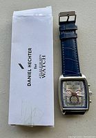 Photo of Daniel Hechter wristwatch with its box/manual showing the branding.