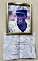 Framed signed photo of Ernie Banks with visible signature and Certificate of Authenticity placed below.