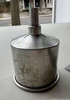 Image showing the full funnel including body and spout, with signs of age and surface wear visible.