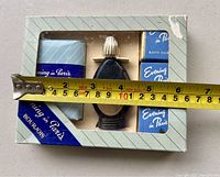 Boxed set of Evening in Paris items including cologne, soap, and two boxes of bath cubes. Tape measure showing box width approx 5 inches.