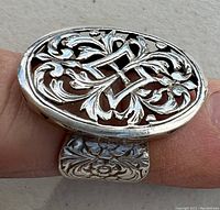 Close-up of the ornate openwork design on the oval ring face