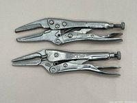 Two vintage needle nose adjustable locking pliers shown from the side, metal with patina and wear.