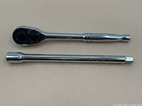 Top view showing ratchet and extension bar side by side, both in chrome finish and ratchet marked Husky 2438.