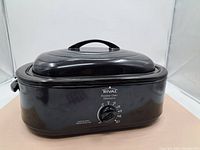 Full side view of the black Rival Roaster Oven with lid and handle on top