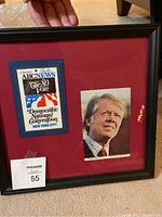 Framed press pass signed by Jimmy Carter and accompanying photo displayed on red matting.