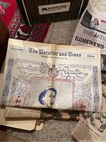 Photo showing The Recorder and Times newspaper with a coronation edition for Queen Elizabeth II featuring elaborate border and dated text.