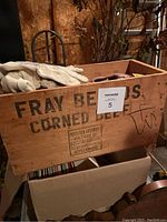 Wooden box labeled FRAY BERNARDOS CORNED containing work gloves on top