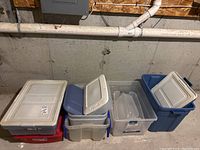 Multiple plastic totes of various sizes and colors, stacked together